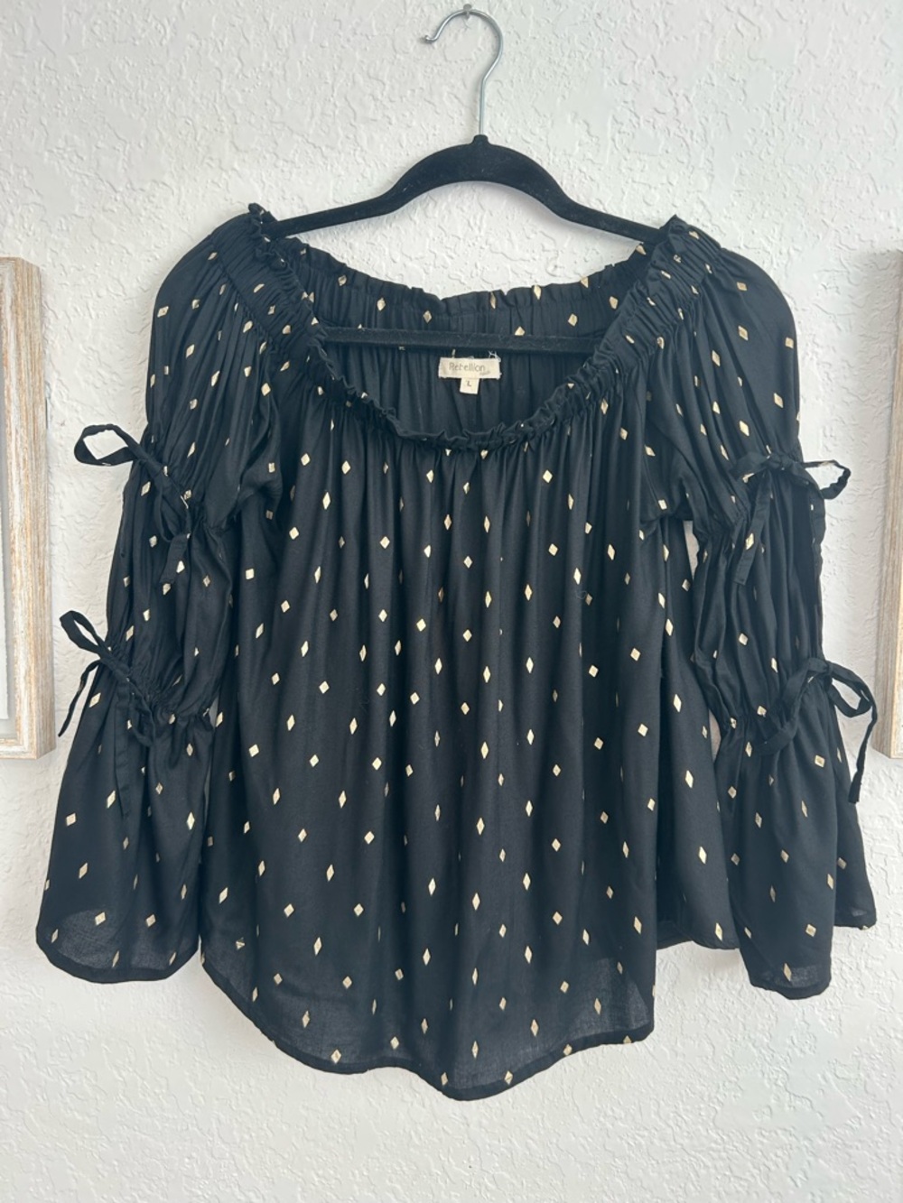 Lightweight black peasant-style top with subtle gold dot detail.